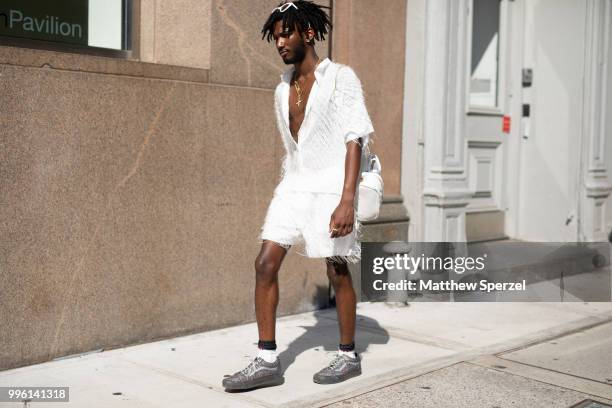 Guest is seen on the street attending Men's New York Fashion Week wearing white fringe outfit on July 10, 2018 in New York City.