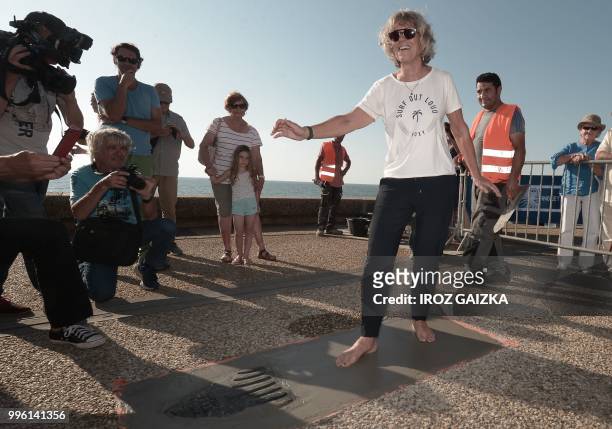 Rench surfer Maritxu Darrigrand leaves her footprint cement slab as she takes part in the inauguration of the Anglet Surf Avenue with other surfers...