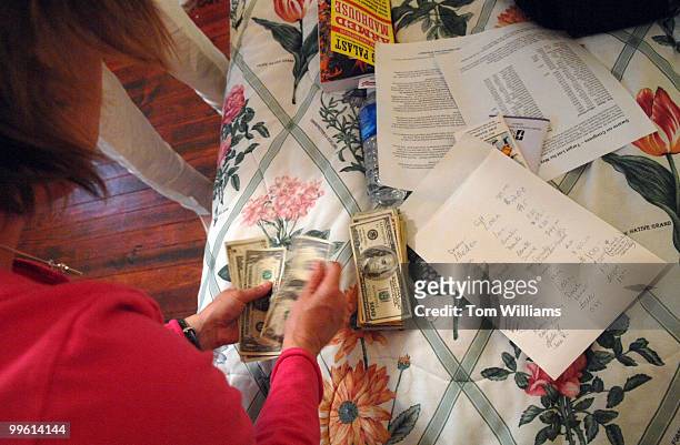 Lori Purdue counts money collected to bail members out of jail at the Code Pink house on 5th street, NE.
