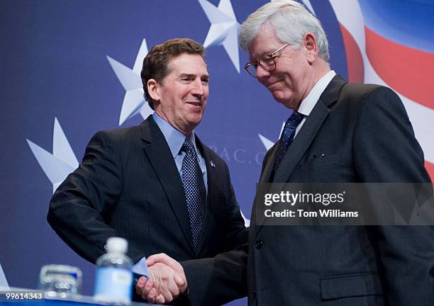 Sen. Jim DeMint, R-S.C., center, greets David Keene, chairman of the American Conservative Union, upon arriving on stage to address the Conservative...