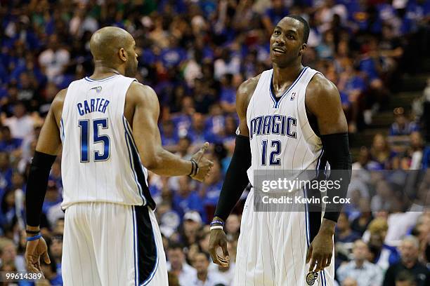 Vince Carter and Dwight Howard of the Orlando Magic talk on court against the Boston Celtics in Game One of the Eastern Conference Finals during the...