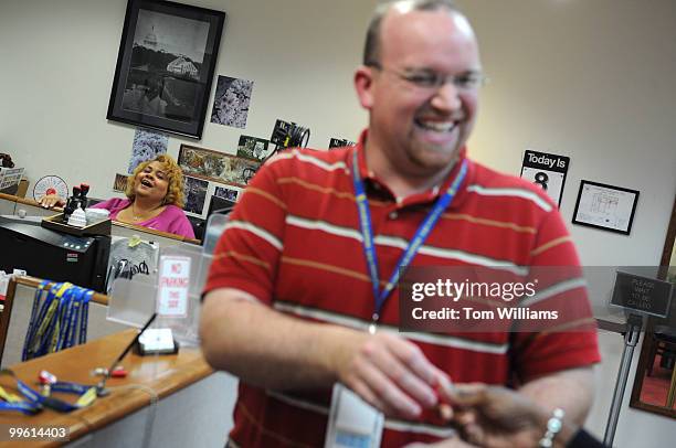 Sam Jacobs, ID office manager, and Karen Browner, ID specialist, share a laugh with a patron while picking out a proper ID attachment at the Senate...