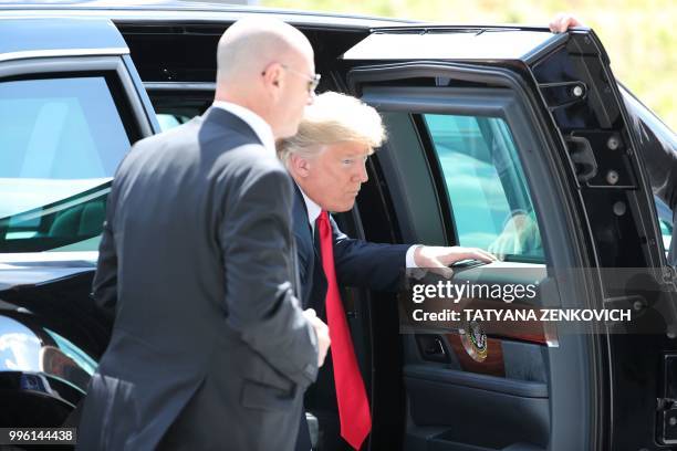 President Donald Trump steps out of the US official state car also known as The Beast as he arrives to attend the NATO summit, in Brussels, on July...