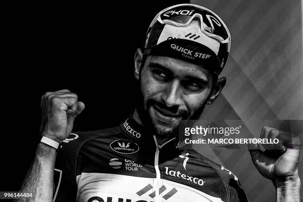 Colombia's Fernando Gaviria celebrates on the podium after winning the fourth stage of the 105th edition of the Tour de France cycling race between...