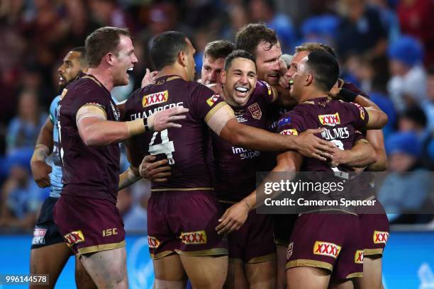 Daly Cherry-Evans of Queensland is congratulated by team mates after scoring a try during game three of the State of Origin series between the...