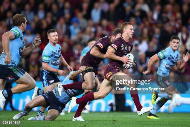 Daly Cherry-Evans of Queensland breaks through the Blues defence during game three of the State of Origin series between the Queensland Maroons and...