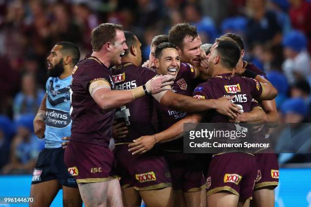 Daly Cherry-Evans of Queensland is congratulated by team mates after scoring a try during game three of the State of Origin series between the...