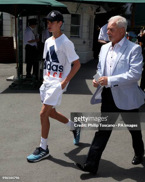 Romeo Beckham and his grandfather Anthony Adams on day nine of the Wimbledon Championships at the All England Lawn Tennis and Croquet Club, Wimbledon.