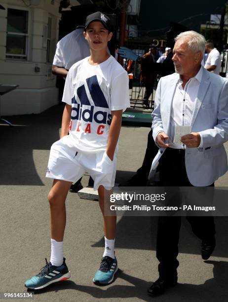 Romeo Beckham and his grandfather Anthony Adams on day nine of the Wimbledon Championships at the All England Lawn Tennis and Croquet Club, Wimbledon.