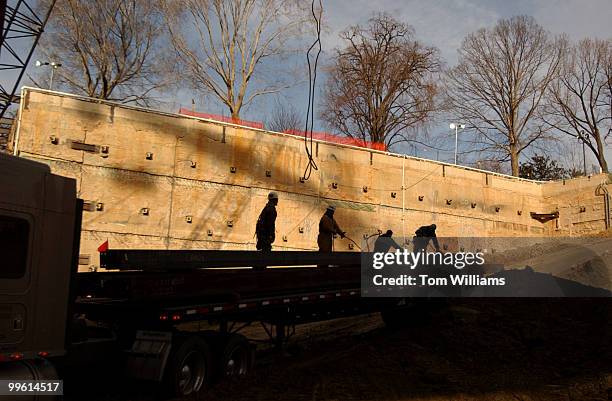 Workers unload steel beams in the pit of the construction site of the Capitol Visitor Center.