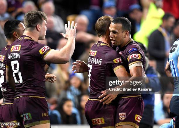 Queensland players celebrate a try by Valentine Holmes of Queensland during game three of the State of Origin series between the Queensland Maroons...