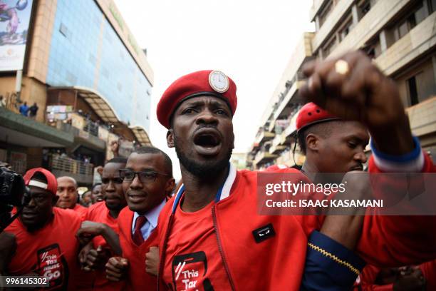 Musician turned politician Robert Kyagulanyi Ssentamu aka Bobi Wine is joined by other activists in Kampala on July 11, 2018 in Kampala during a...