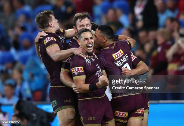 Daly Cherry-Evans of Queensland is congratulated by team mates after scoring a try during game three of the State of Origin series between the...