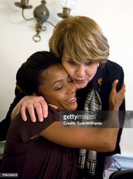Olympic Gold Medalist Dominique Dawes gets a hug from Rep. Louise Slaughter, D-N.Y., during a briefing on the High School Athletics Accountability...