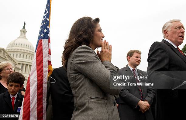 Tammy Darvish, vice president of DARCARS Toyota, listens to House Majority Leader Steny Hoyer, D-Md., during a news conference on the Automobile...