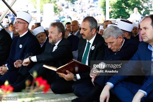 Turkish Justice Minister Abdulhamit Gul recites from the holy Quran while burial ceremony of newly identified 35 victims during the 23rd anniversary...
