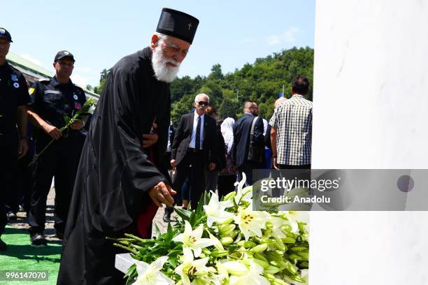 Man places a flower for victims following the burial ceremony of newly identified 35 victims during the 23rd anniversary of the 1995 Srebrenica...