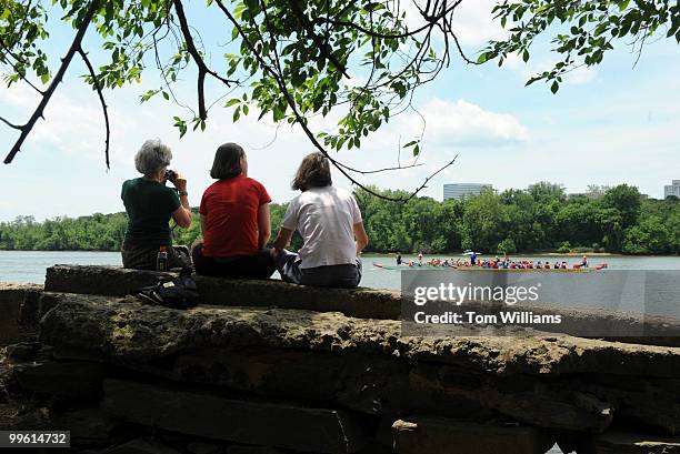 From left, Susan Weld, Alice Sturm and her daughter Joanna Sturm, watch races from a bank on the Potomac River during the D.C. Dragon Boat Festival,...