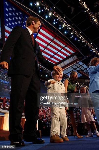 From left, Sen. John Edwards, D-N.C., son Jack, daughters Cate and Emma Claire, and wife Elizabeth mug for the crowd, on the night Edwards was...