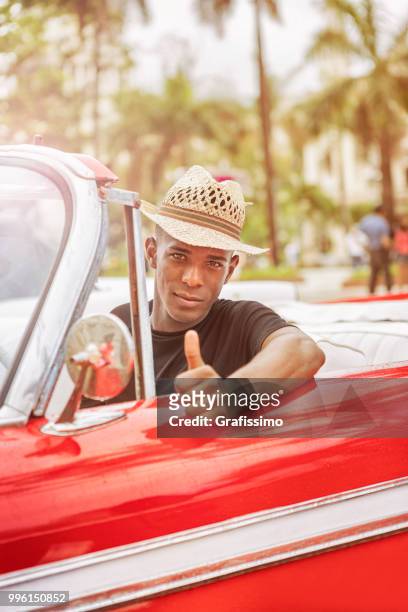cuban taxi driver giving ok sign driving vintage car in cuba old havana - taxi sign stock pictures, royalty-free photos & images