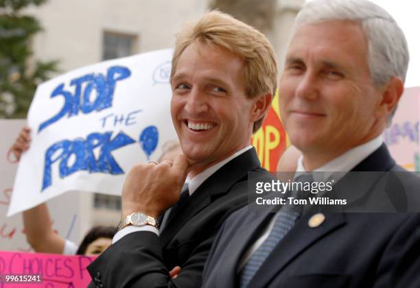 Reps. Jeff Flake, R-Ariz., left, and Mike Pence, R-Ind, share a laugh at a rally to support a House resolution, scheduled for a vote Thursday, that...