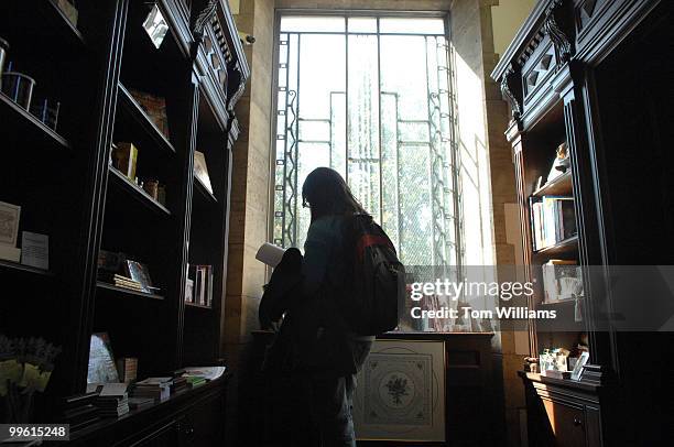 Justine Ney of Iowa, looks through a book in the gift store at the Folger Shakespeare Library.