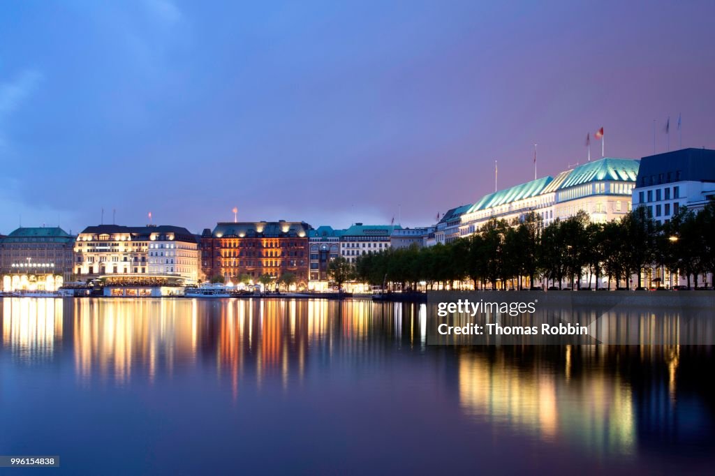 View across the Inner Alster towards representative office buildings, hotels, and commercial buildings on Jungfernstieg promenade, Hamburg, Germany