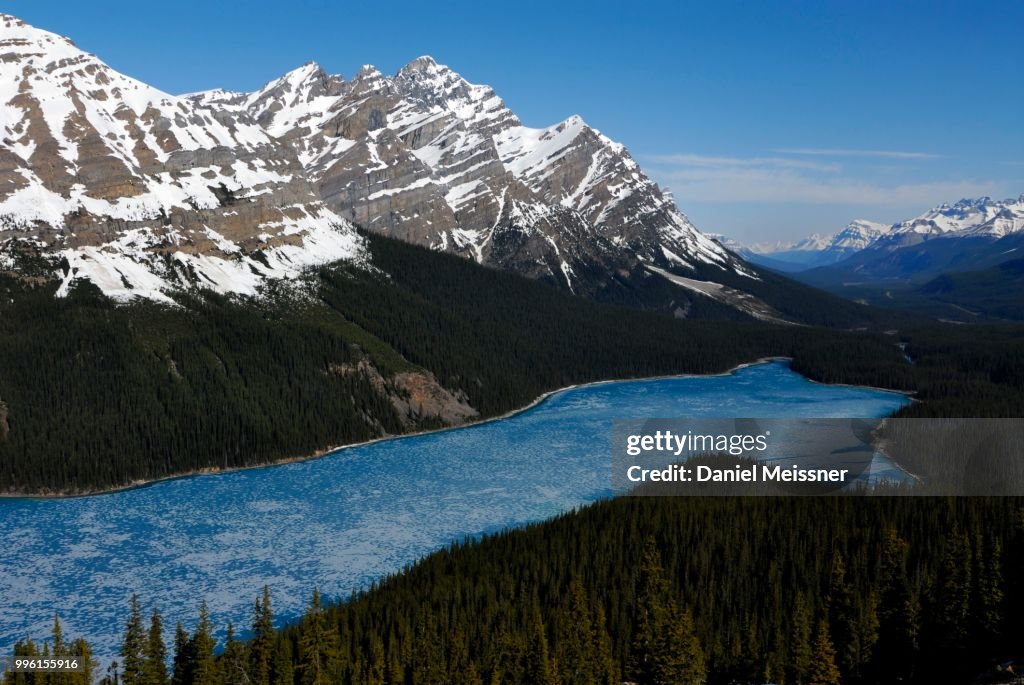 Glacial Peyto Lake in spring with a thin sheet of ice, the summit of Mt. Patterson at the back, Banff National Park, Rocky Mountains, Alberta Province, Canada