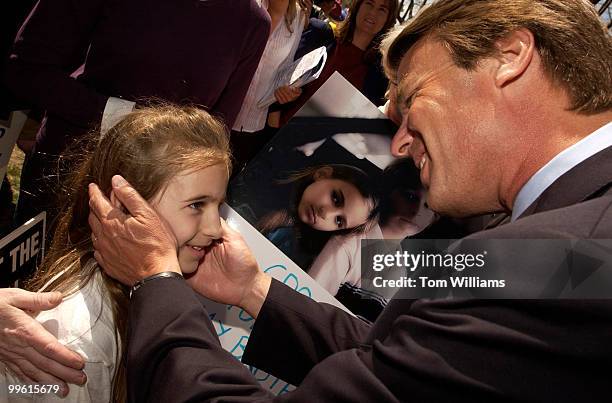 Former Senator John Edwards greets Jordan Segal of Greensboro, N.C., after a news conference with Sen. Ted Kennedy, D-Mass., to promote a fair...