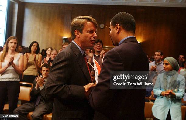 Sen. John Edwards, D-N.C., has a word with Kenneth Edmonds, Chief of Staff for Rep. Jesse Jackson, Jr., D-Ill., at a 21st Century Democrats event...