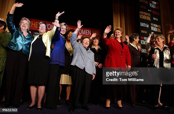 Sen. Barbara Mikulski, D-Md., center, Sen. Debbie Stabenow, D-Mich., right, in red, and Ellen Malcolm, far left, in green, president of Emily's List,...