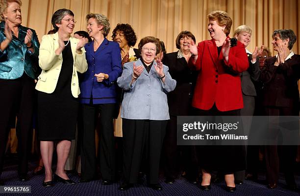 Sen. Barbara Mikulski, D-Md., center, Sen. Debbie Stabenow, D-Mich., right, in red, and Ellen Malcolm, far left, in green, president of Emily's List,...