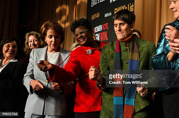 From left in gray suit, House Minority Leader Nancy Pelosi, D-Calif., Rep. Gwen Moore, D-Wis., Rosa DeLauro, D-Conn., and Ellen Malcolm, president of...