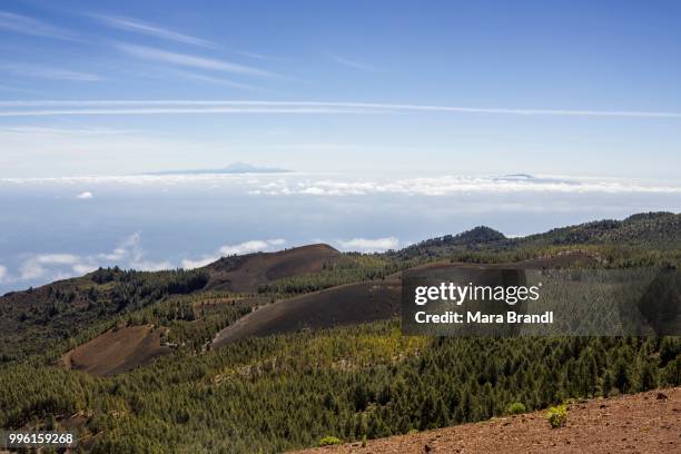 volcanic landscape on the --ruta de los volcanes--, volcano route, at the back the island of tenerife with mount teide and the island of el hierro, cumbre vieja natural park, la palma, canary islands, spain - ruta stock pictures, royalty-free photos & images