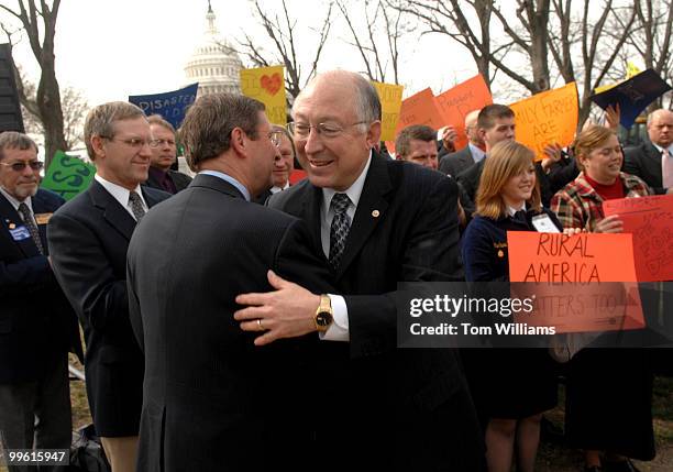 Sen. Ken Salazar, D-Colo., right, hugs Sen. Kent Conrad, D-N.D., at a news conference to call on President Bush to stop resisting a $4.15 billion...