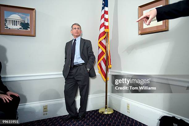 Anthony Fauci, director of National Institute of Allergy and Infectious Diseases , waits to speak at a briefing on how the National Institutes of...