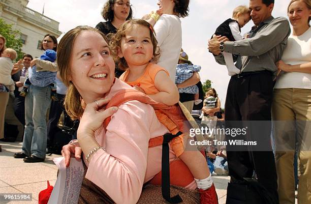 Zena Carmel~Jessup of Silver Spring, carries daughter Lyla, 13 months, at a "Nurse-In" to introduce the "Breastfeeding Promotion Act", introduced by...