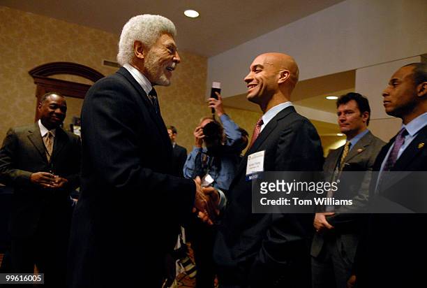 Mayor of Washington D.C. Adrian Fenty, right, speaks with mayor of Oakland, Ca., and former Congressman Ron Dellums, outside the ballroom of the...