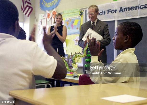 Rep. Bill Goodling, R-PA, is applauded by Lavar Bragg and other students at Moten Elementary School in SE, Washington after the Congressman taught a...