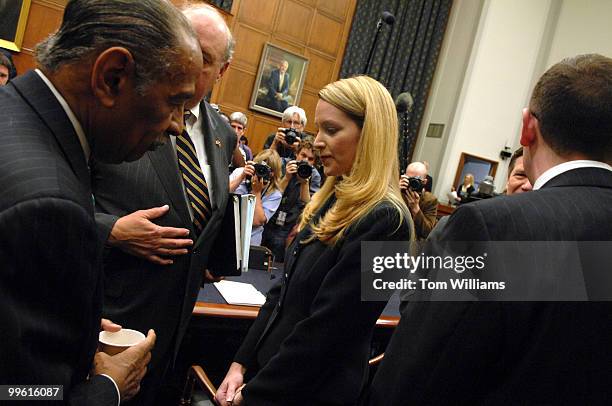 Monica Goodling, former Justice Department White House liaison, greets House Judiciary Committee Chairman John Conyers, D-Mich., before a hearing on...