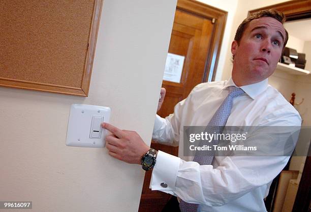 Daniel Murray talks about dimmers switches installed in the office of Sen. Wayne Allard, R-Colo., as part of the Green the Capitol Initiative.