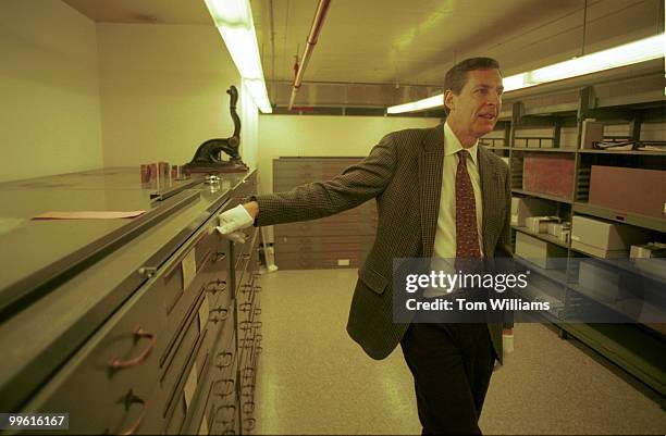 Director of the Center for Legislative Archives, Michael Gillette, prepares to show historical documents to reporters, in the Archives vault.