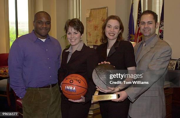 Climbers form left, Donny Wiliams, Ellie Heath, Jessica Katlin and Enrique Fernandez Roberts pose with basketballs from Senator Kohl's team, the...