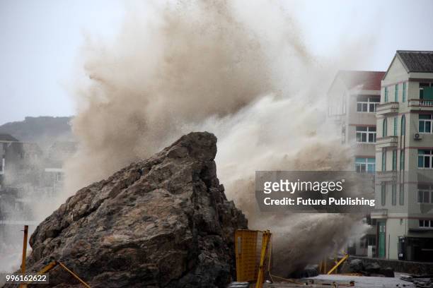Tidal waves hit the embankment near a seaside residential block in Wenling in east China's Zhejiang province Wednesday, July 11, 2018. Typhoon Maria...