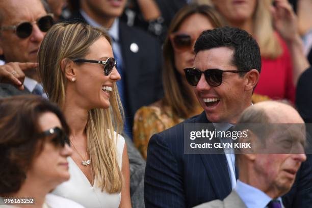 Irish golfer Rory McIlroy and wife Erica sit on centre court to watch Serbia's Novak Djokovic play Japan's Kei Nishikori during their men's singles...