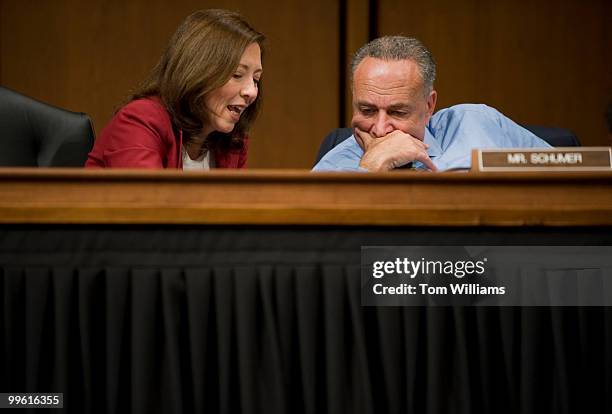 Sens. Maria Cantwell, D-Wash., left, and Charles Schumer, D-N.Y., confer during opening statements of the Senate Finance Committee's full committee...