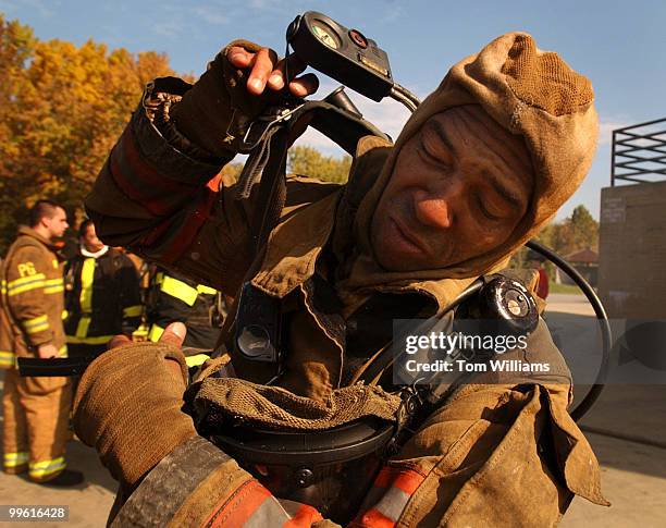 James Artis Jr., prepares for a live fire demonstration during the Maryland Fire Rescue Institute annual Congressional Firefighting Training Program...