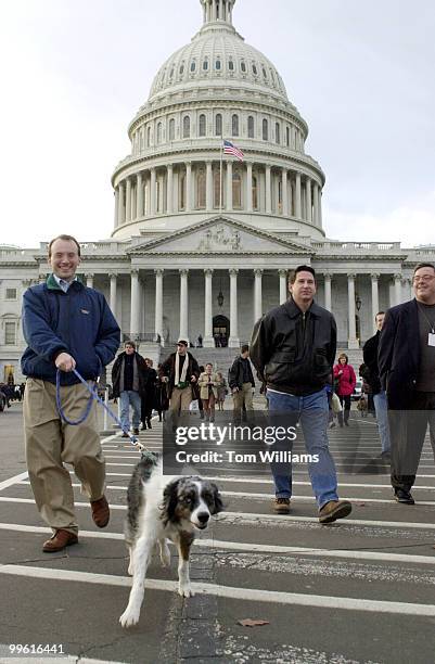 Merrell Moorehead, left, of the House Intelligence Committee and Australian Shepard, "Woody" make their way out of the Capitol Building during...