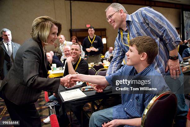 Speaker Nancy Pelosi, D-Calif., greets Josh McDonnell and his father Mannix, of the Bellingham Fire Department, after she spoke at the The...