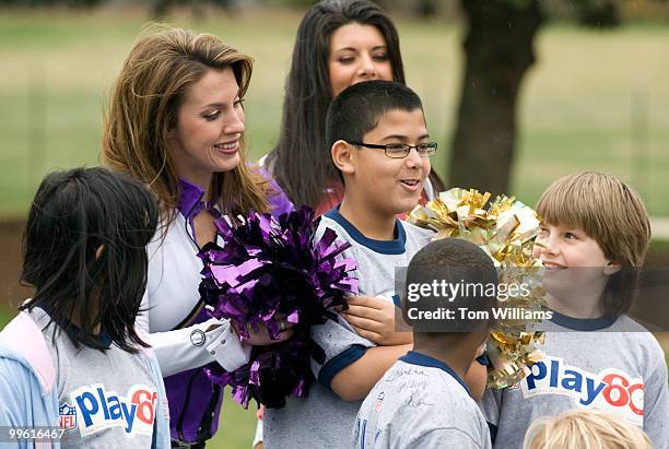 Tasha M, cheerleader for the Baltimore Ravens, tries to warm up David Cruz of Germantown, during a news conference to reintroduce the Fitness...